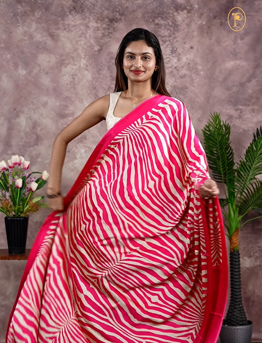 Pink Colour satin model saree featuring Zibra print on body. Ajrak & zibra print on pallu with jhumka tassels, comes with contrast plain blouse piece.