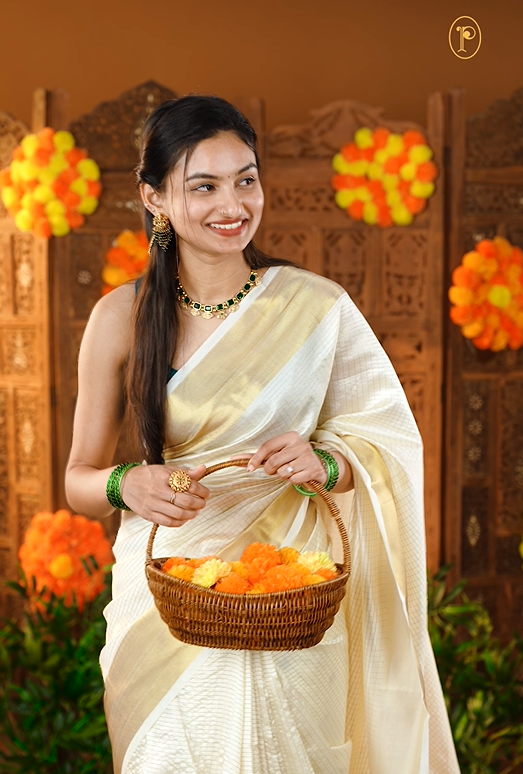 Cream colour Semi Soft Silk saree Featuring Gold zari check Pattern on body, complemented by Double side Bavanchi Border with striped pallu, Comes with Running blouse With multi colour Buttas.