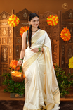 Cream colour Semi Soft Silk saree Featuring Gold zari check Pattern on body, complemented by Double side Bavanchi Border with striped pallu, Comes with Running blouse With multi colour Buttas.