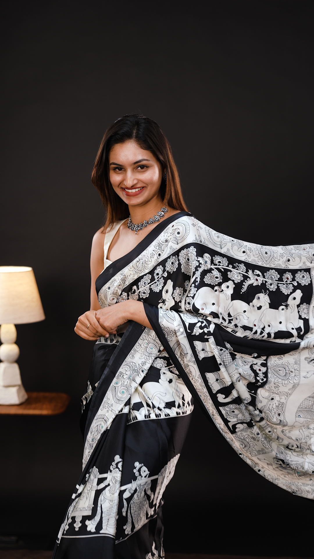 Black Colour Semi Modal silk saree featuring Kalamkari print associate with mirror details on body, matching kalamkari print border.