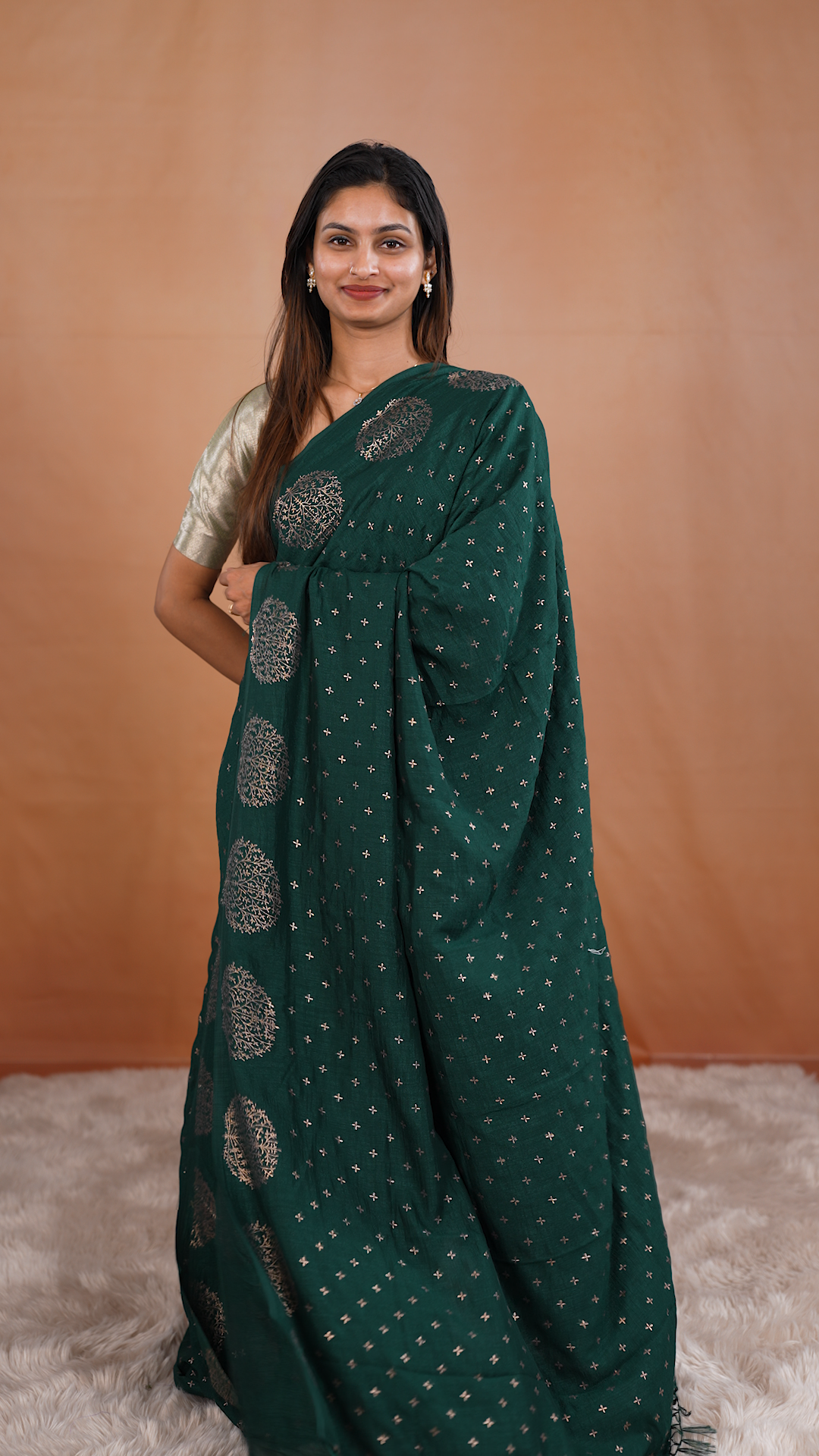 Bottle green colour vijithra silk saree featuring small zari details on body, Tree design border.