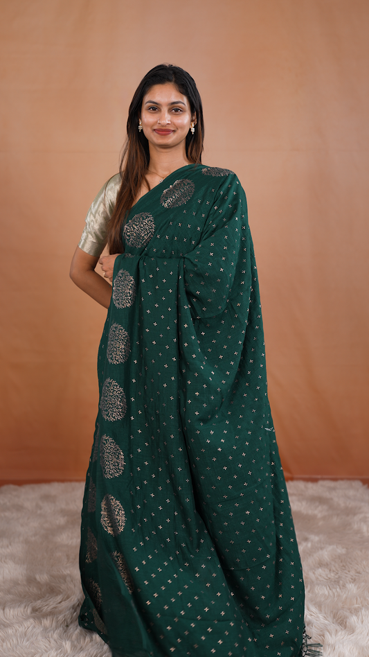 Bottle green colour vijithra silk saree featuring small zari details on body, Tree design border.