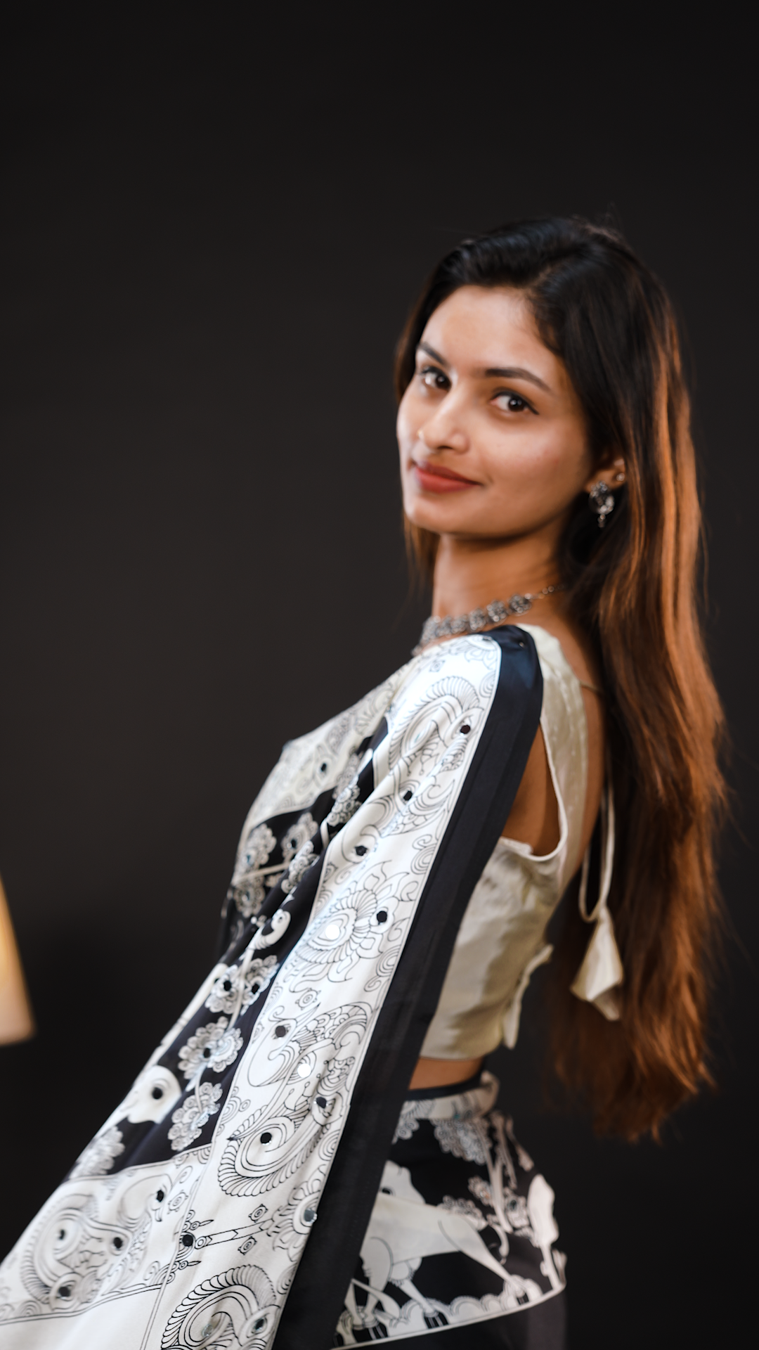 Black Colour Semi Modal silk saree featuring Kalamkari print associate with mirror details on body, matching kalamkari print border.