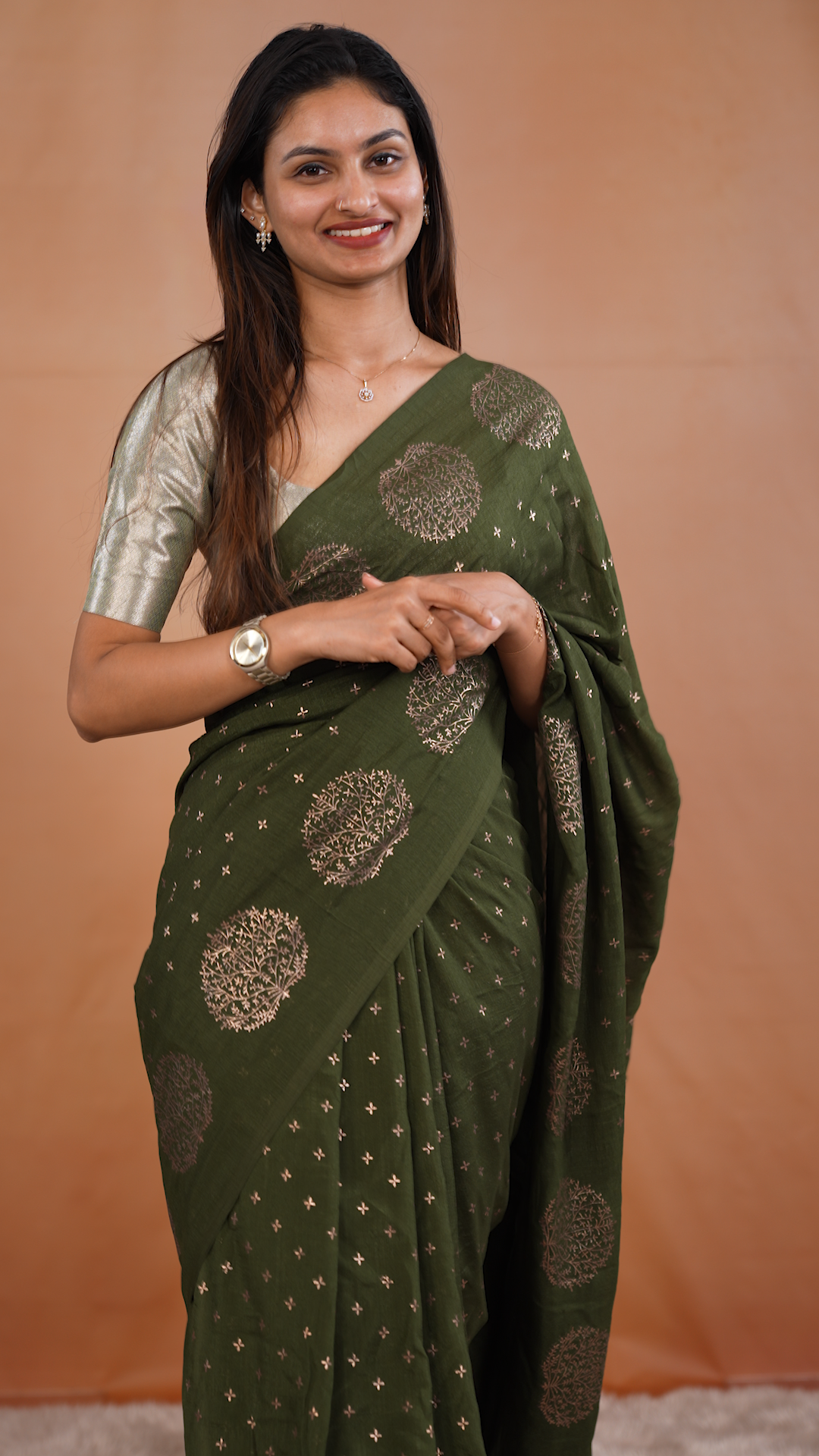 Olive colour vijithra silk saree featuring small zari details on body, Tree design border.