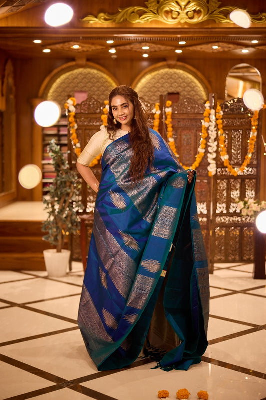 Borderless peacock blue thazampoo rekku, and geometric patterns zari woven Kanchipuram silk saree, zari pallu of manga and paiyaadi kattam designs