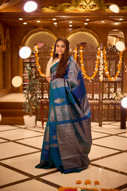 Borderless peacock blue thazampoo rekku, and geometric patterns zari woven Kanchipuram silk saree, zari pallu of manga and paiyaadi kattam designs
