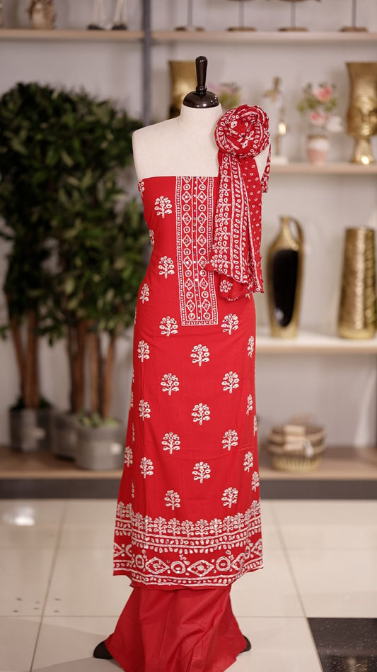 Brignt Red colour cotton churidhar material featuring floral prints with delicate mirror design on the top, paired with a matching bottom and printed dupatta
