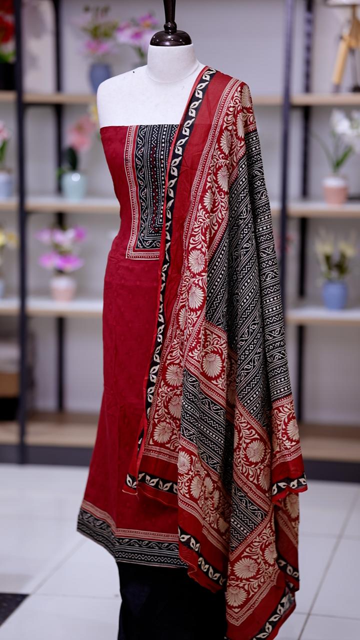 Red colour cotton salwar suit with deep red yoke featuring subtle sequin work on the neckline, Paired with a plain bottom and a printed cotton dupatta, this set blends comfort with traditional elegance.