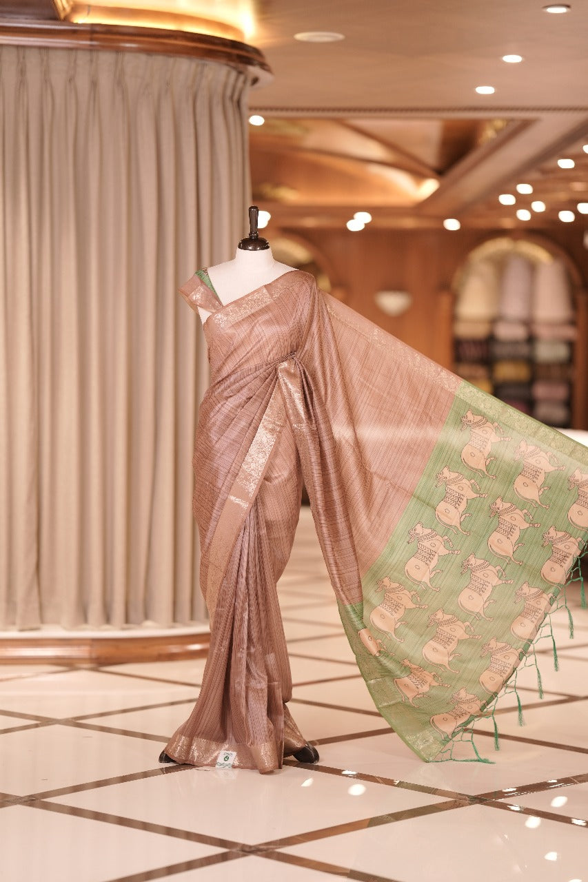 Mauve & green colour Dolla silk saree featuring a striped body with a matching golden zari border, The pallu showcases exquisite Kalamkari prints, complemented by a contrast printed blouse.