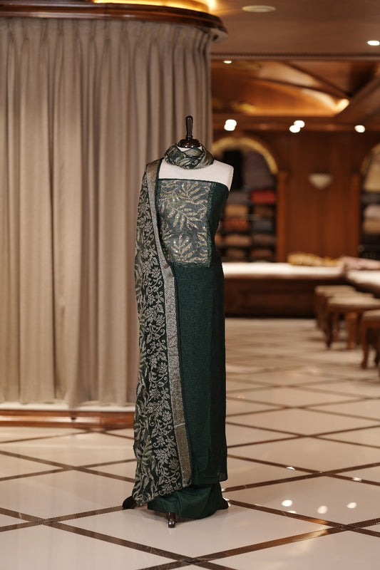 Green colour Vichithra silk Salwar suit featuring rich Leaf design & Mirror worked neckline, Chiffon printed dupatta & paired with a plain bottom.