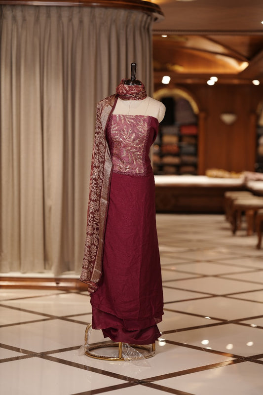 Maroon colour Vichithra silk Salwar suit featuring rich Leaf design & Mirror worked neckline, Chiffon printed dupatta & paired with a plain bottom.