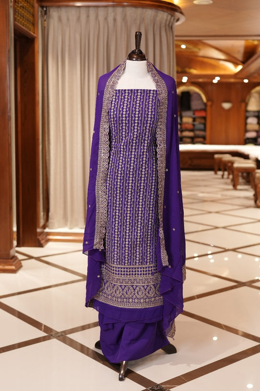 Violet Colour Georgette top adorned with gold zari and sequin work, paired with a scallop bordered dupatta featuring golden zari embroidery and a plain bottom.