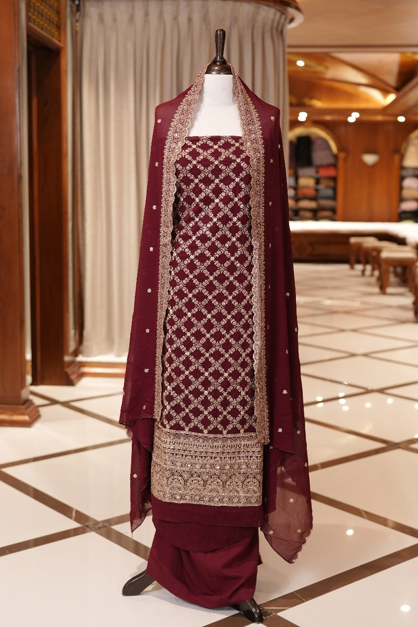 Maroon Colour Georgette top adorned with gold zari and sequin work, paired with a scallop bordered dupatta featuring golden zari embroidery and a plain bottom.