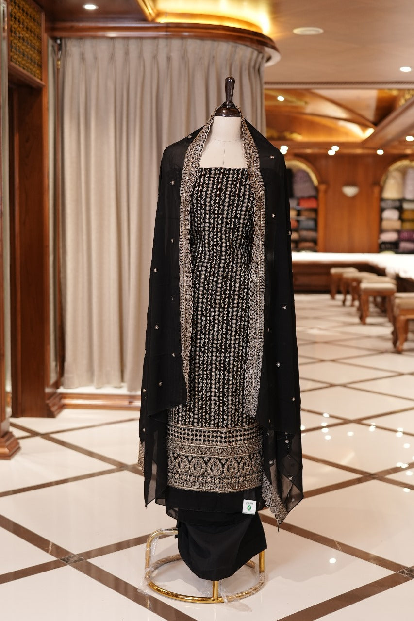 Black Colour Georgette top adorned with gold zari and sequin work, paired with a scallop bordered dupatta featuring golden zari embroidery and a plain bottom.