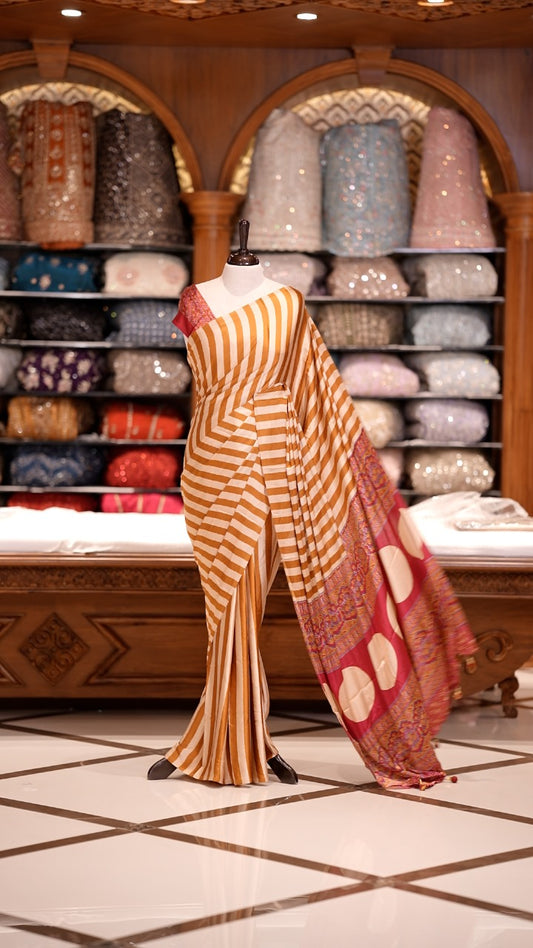 Cream and Yellow striped Semi modal silk saree highlighted with a rich pallu featuring artistic motifs, paired with a matching blouse