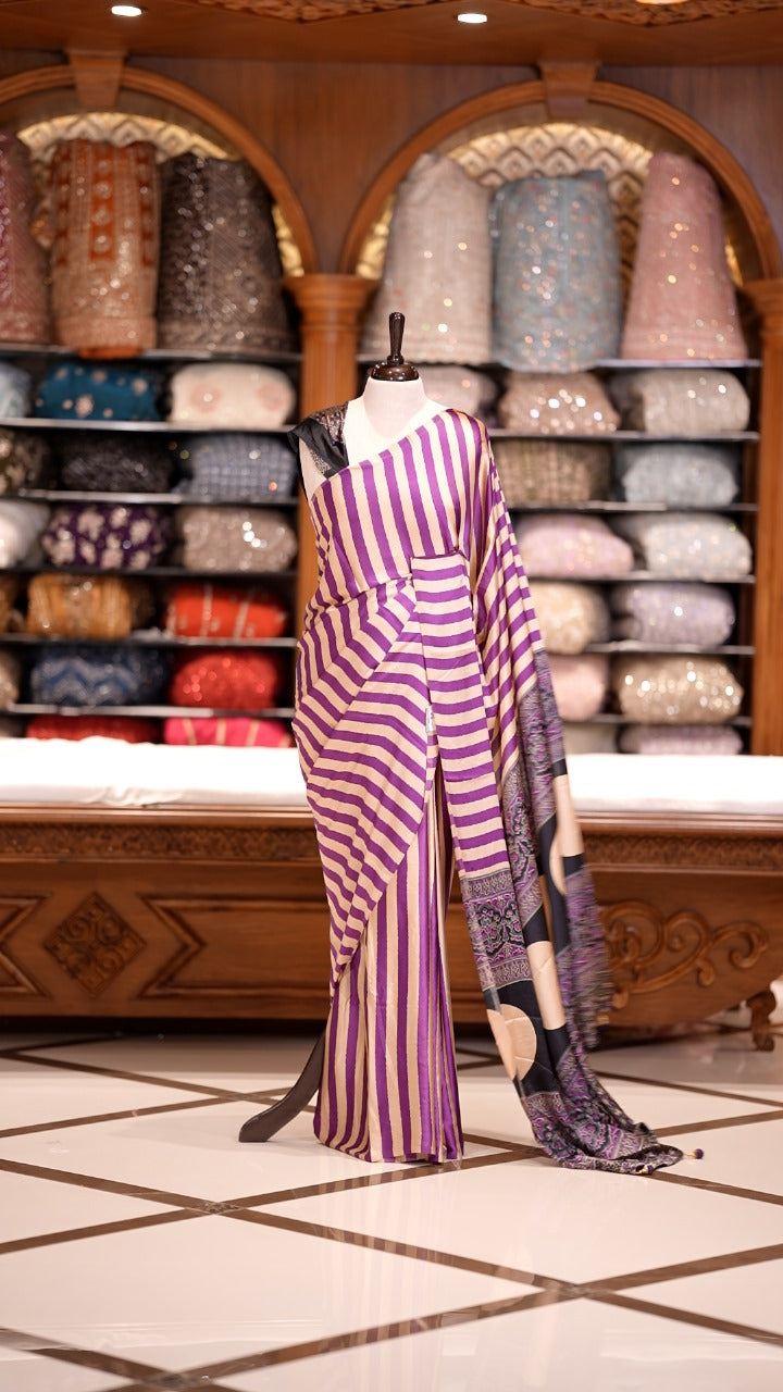 Cream and Magenta striped Semi modal silk saree highlighted with a rich pallu featuring artistic motifs, paired with a matching blouse