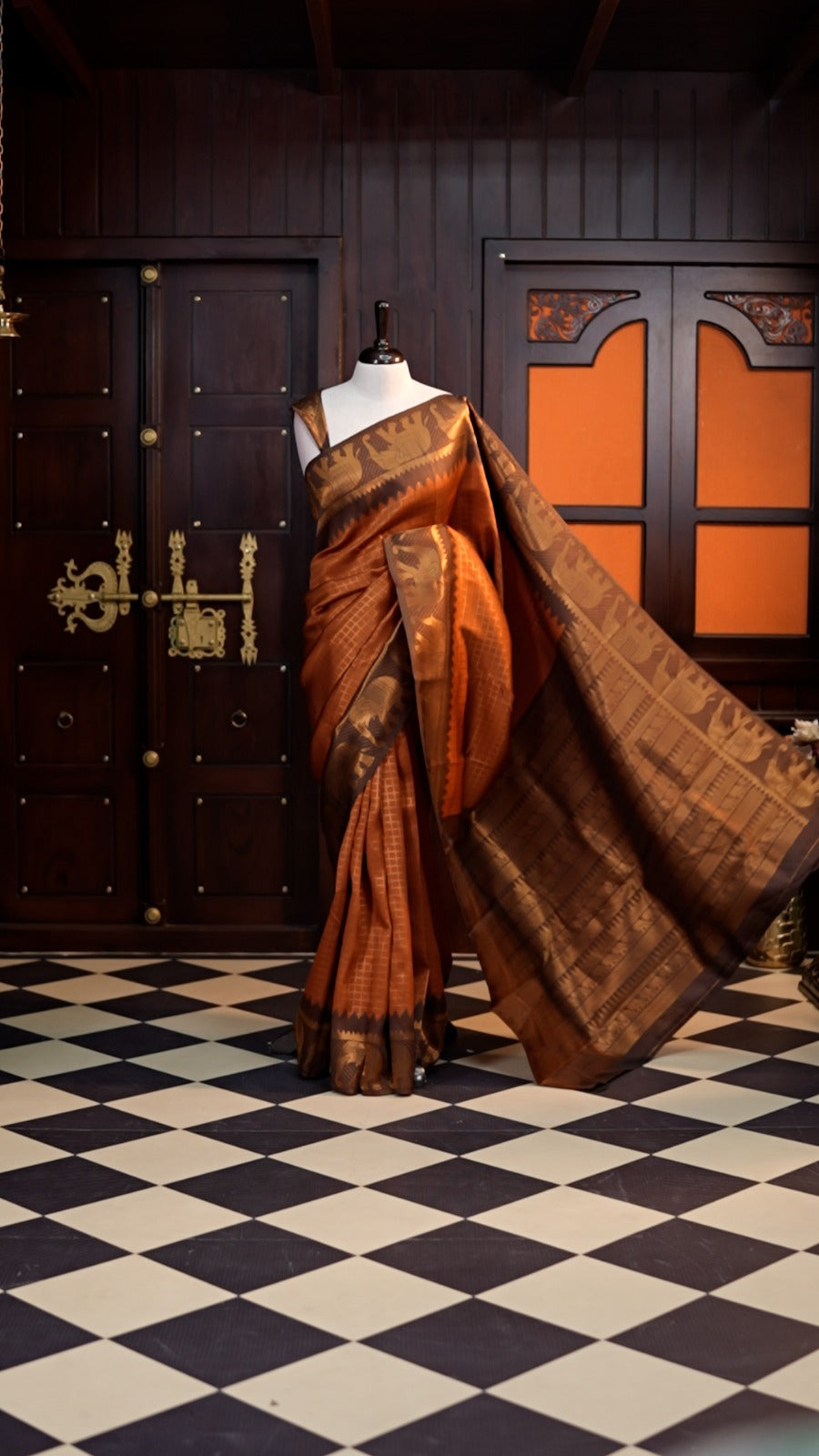 Copper colour Kanchi silk saree featuring a contrast border with Elephant motifs and elegant Check weaving
