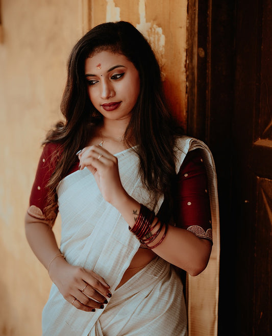 White colour colour cotton Kerala saree with Silver zari Stripes on Body, complemented by a classic zari border