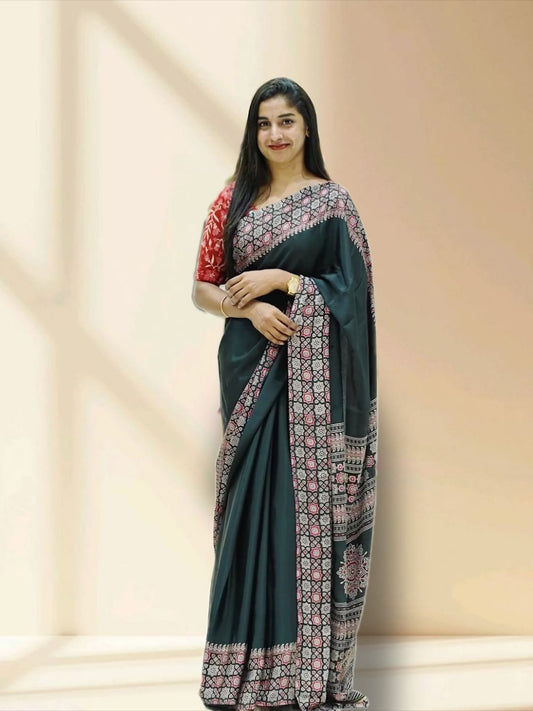 Black colour semi modal saree featuring an intricately woven multicolour ethnic patterned border and pallu, highlighted with traditional motifs, and paired with a matching blouse