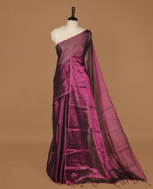 Wine colour semi tissue saree featuring an elegant plain body, designed without a border and comes without a blouse piece.