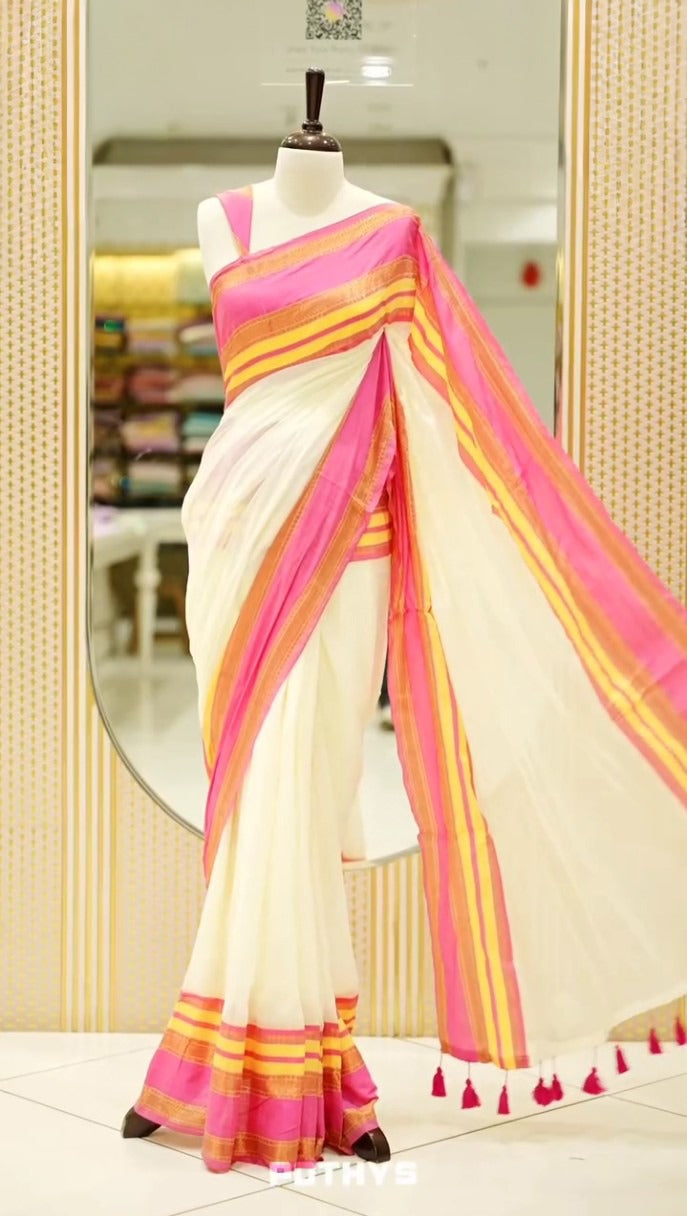 off white color mul cotton saree featuring elegant plain body, complemented by multicolour border, tessels at pallu end.