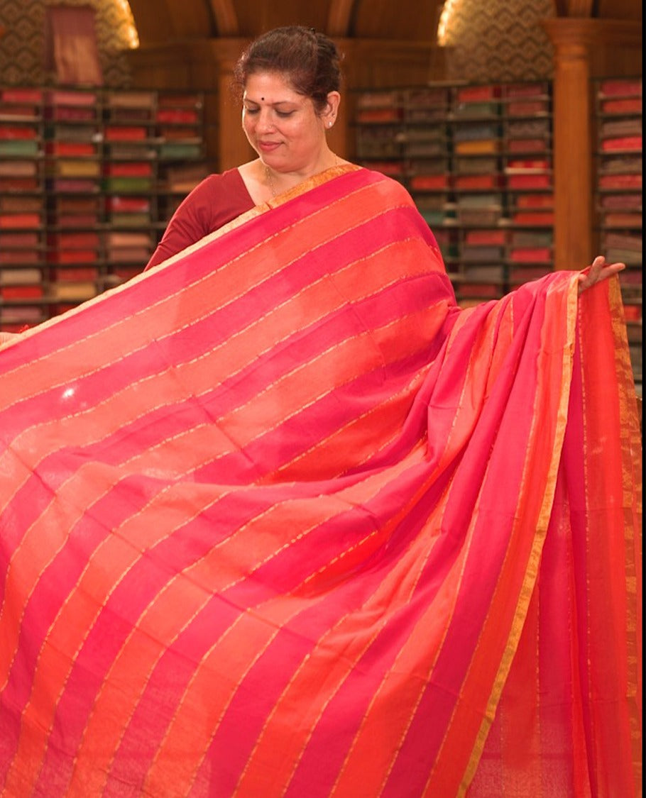 Pink & orange colour Mul cotton saree featuring stripes on body, without border, without blouse piece.