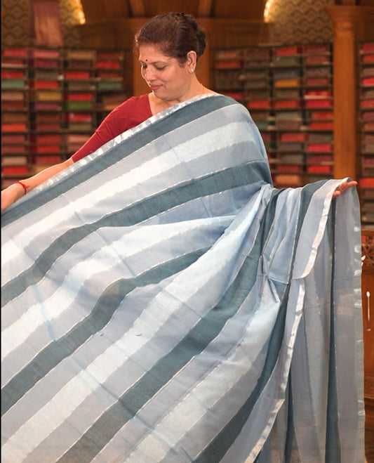 Blue colour Mul cotton saree featuring stripes on body, without border, without blouse piece.