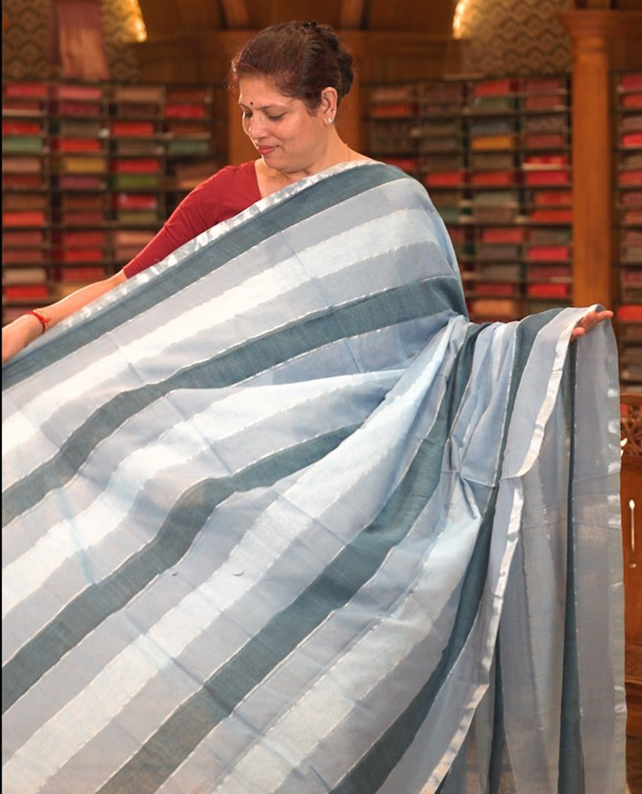 Blue colour Mul cotton saree featuring stripes on body, without border, without blouse piece.