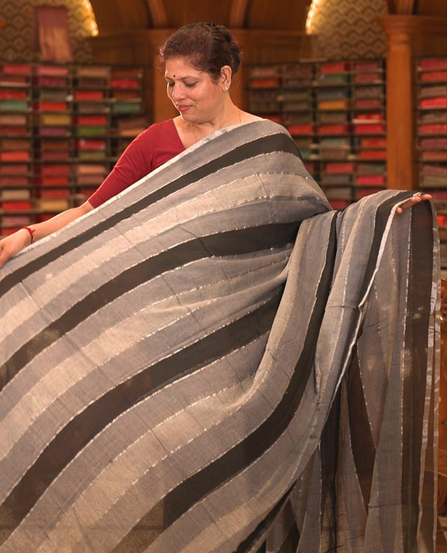 Grey & Black colour Mul cotton saree featuring stripes on body, without border, without blouse piece.