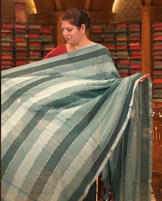 Green colour Mul cotton saree featuring stripes on body, without border, without blouse piece.