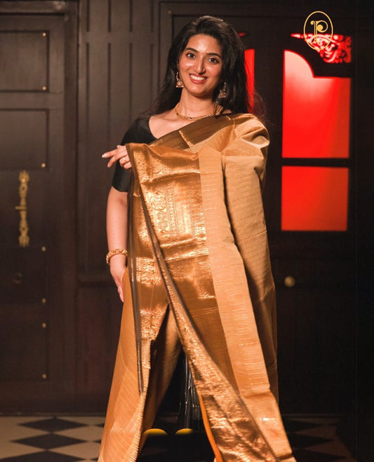 Beige colour chettinad cotton saree Highlighting Gold zari striped body, contrast Dark chocolate colour traditional border, paired with matching blouse piece.
