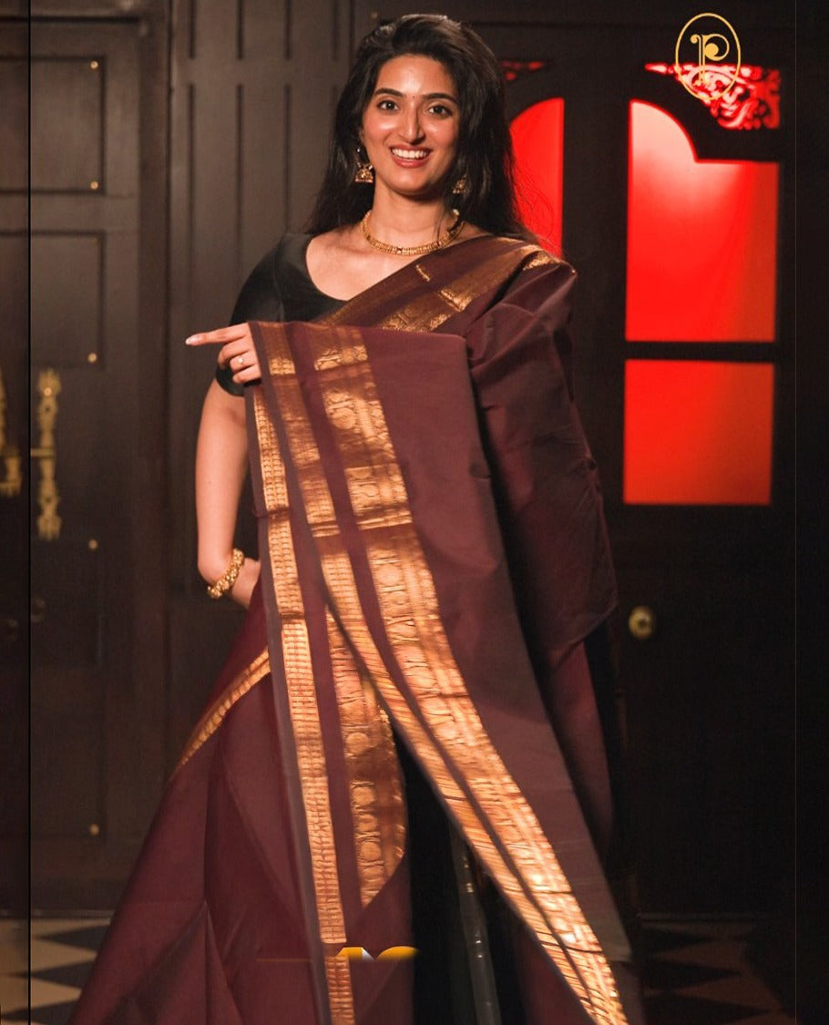Chocolate colour chettinad cotton saree Highlighting Gold zari striped body, traditional mustard border, paired with matching blouse piece.