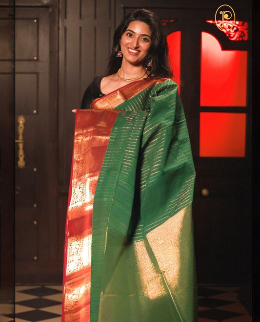Bottle Green colour chettinad cotton saree Highlighting Gold zari striped body, contrast maroon colour traditional border, paired with matching blouse piece.