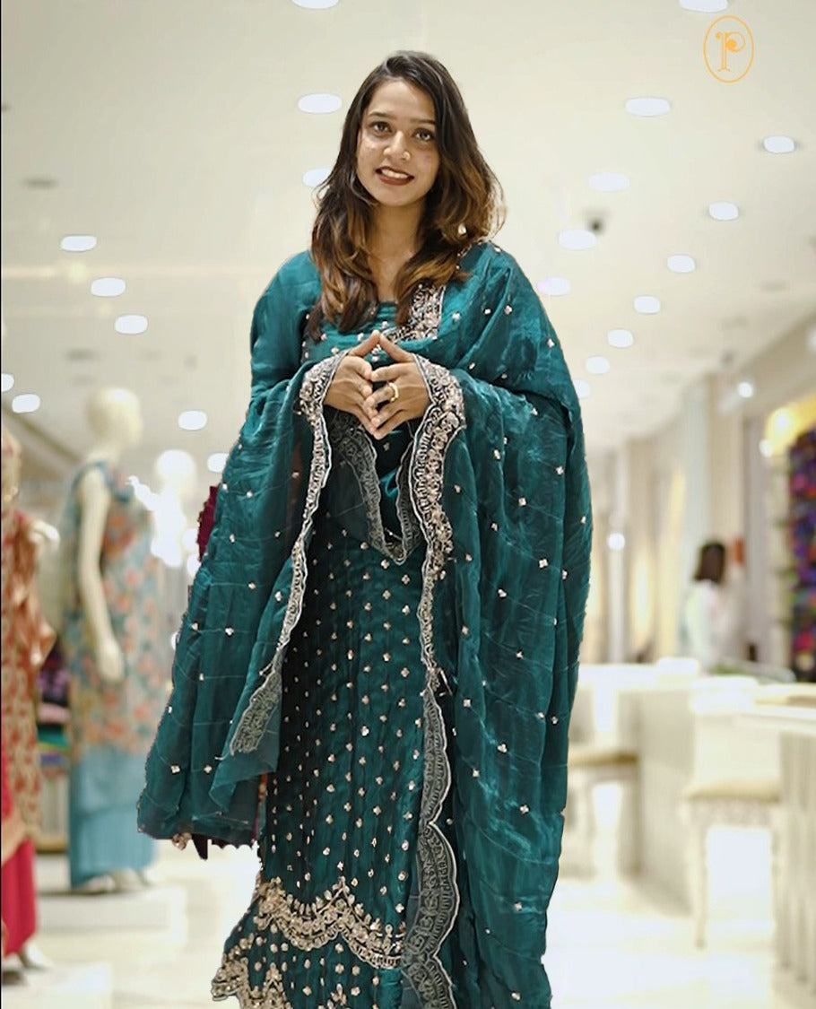 Teal blue colour Fenty silk salwar material highlighting gold sequins on body and scalp design on border, matching dupatta with scalp design, paired with matching bottom.