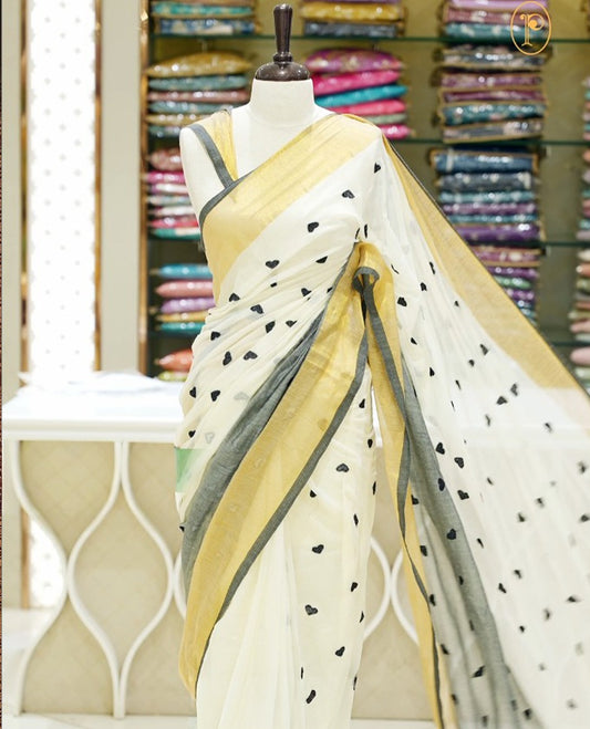 Black and off-white mul cotton saree featuring a thread heart designed body, complemented by a Kasavu border, without a blouse piece.