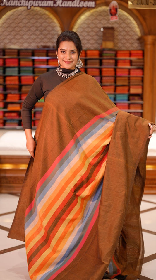 Light Brown Colour Mul Cotton Saree featuring Multi colour Line pattern on body, enhanced with Multi colour Pallu.