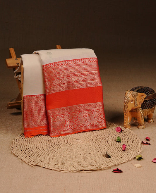 Cream colour Traditional Kancheepuram silk saree featuring gold zari motifs on body, enhanced with contrast Orange with traditional border, paired with matching blouse piece.