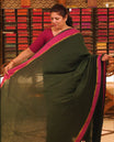Bottle green colour Mul Cotton saree featuring a simple plain body with a contrast border, offering a classic and elegant look. Comes without a blouse piece.