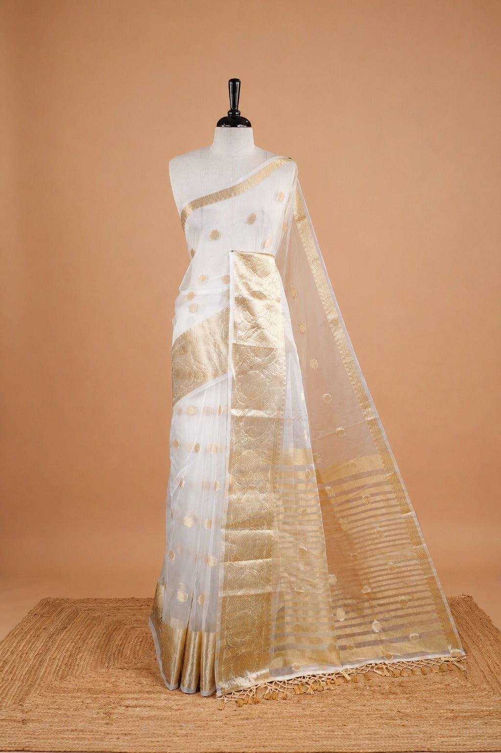 White Colour Semi Organza Saree Featuring Elegant Gold zari Polka dot Detailing on body, Traditional border, comes with matching blouse piece.