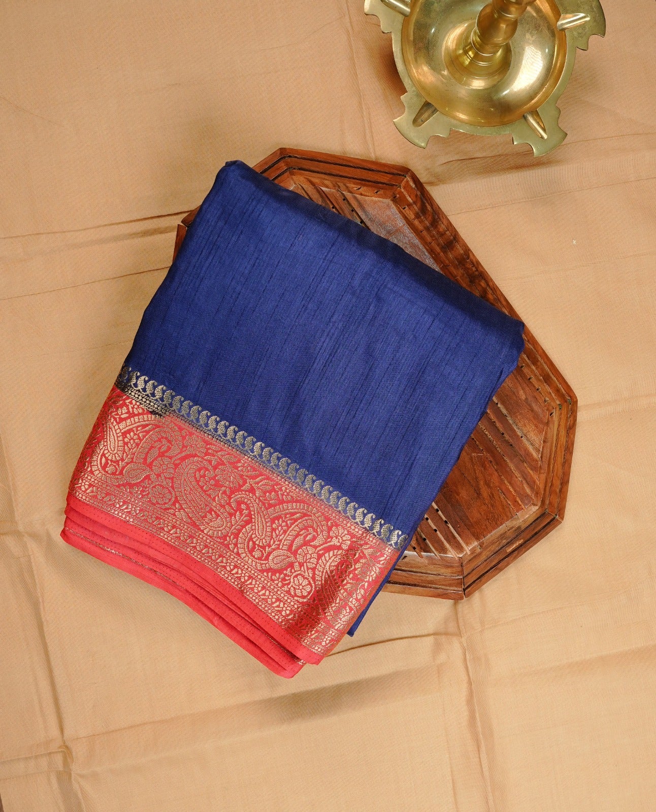 Blue colour semi Tussar saree featuring Elegant plain body, Enhanced with Contrast Pink colour with Gold zari Border, with matching blouse.