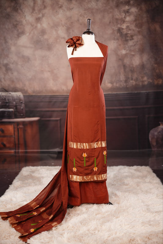Brown colour Semi silk Salwar Material Featuring Traditional Gold Kasav With Lotus print border, paired with matching Semi silk Dupatta & bottom.