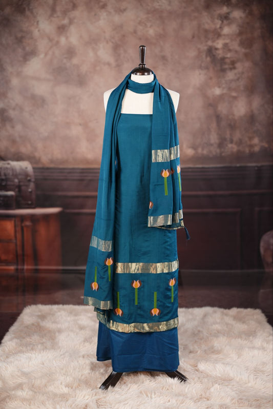 Peacock Blue colour Semi silk Salwar Material Featuring Traditional Gold Kasav With Lotus print border, paired with matching Semi silk Dupatta & bottom.