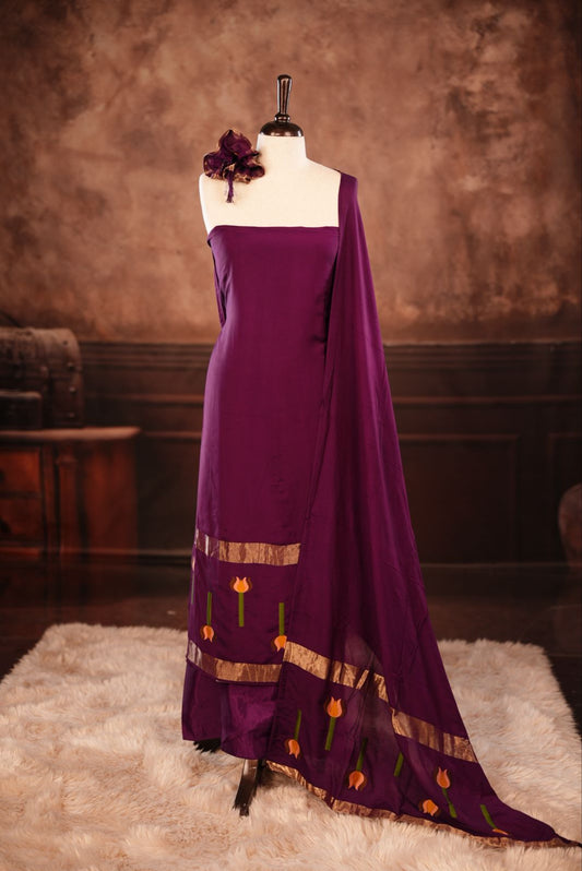 Purple colour Semi silk Salwar Material Featuring Traditional Gold Kasav With Lotus print border, paired with matching Semi silk Dupatta & bottom.