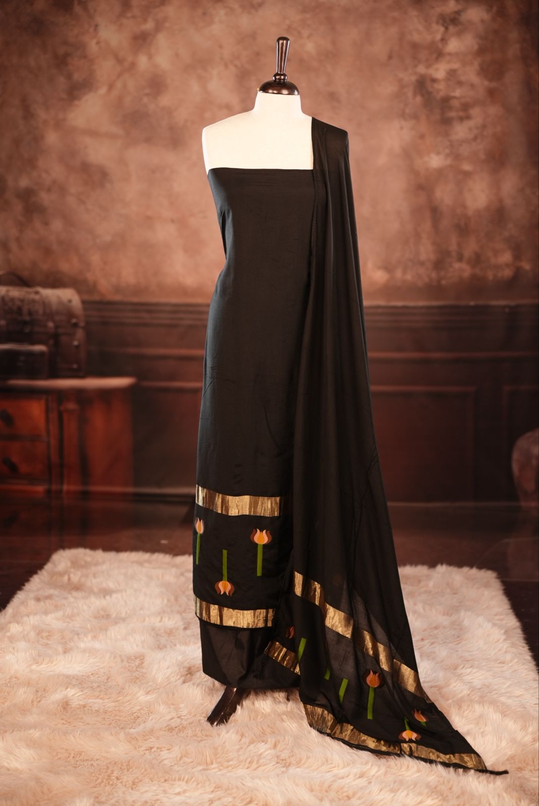 Black colour Semi silk Salwar Material Featuring Traditional Gold Kasav With Lotus print border, paired with matching Semi silk Dupatta & bottom.