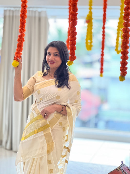 Cream colour Semi Soft Silk saree Featuring Gold zari Box Pattern on body, complemented by Gold zari border & Classic Gold zari zigzag patterned pallu, Comes with Running blouse.