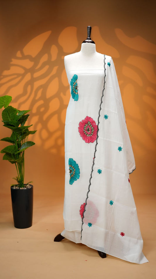 White Colour Mul Chanderi Salwar Material Featuring Pink Colour Floral Thread Work on body, paired with matching santoon Material Bottom & Floral thread Worked motifs And Scallop Embroidery Black Border Dupatta.
