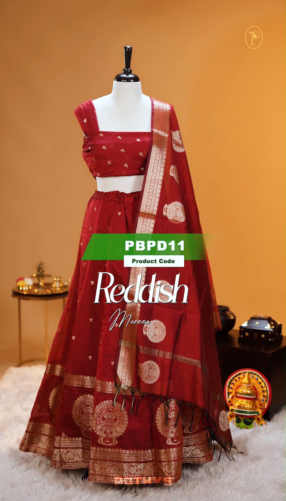 Reddish Maroon colour Chanderi Silk semi stitched Dhavani Set featuring beautiful Buttas on skirt With Kathakali Design border, same material dupatta with Same design & blouse.