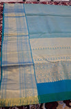 blue colour Kanchipuram pattern Manthrakodi saree featuring golden zari box jacquard with small zari motifs across the body, traditional zari border, zigzag bavanji detailing, and plain zari blouse piece. (Copy)