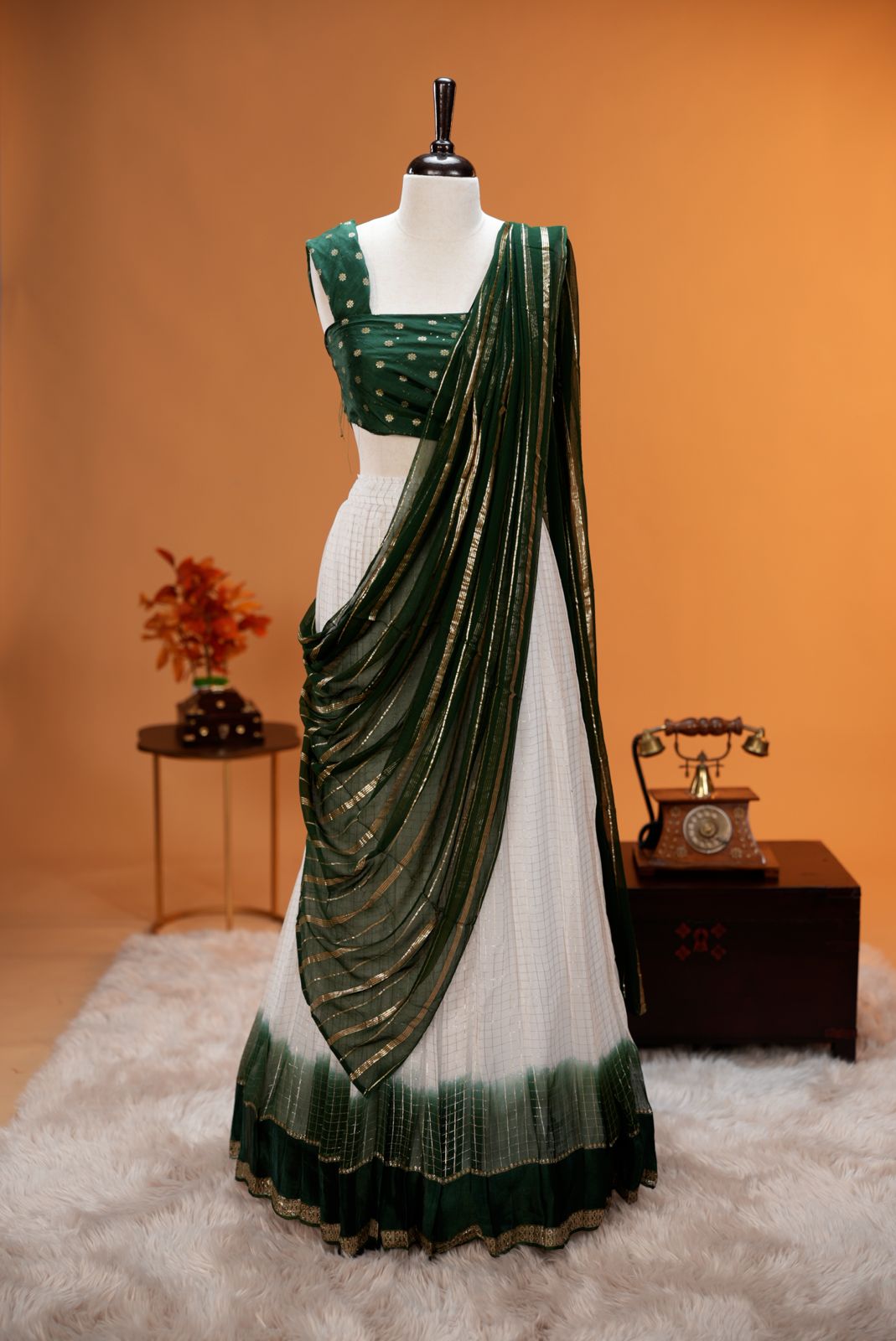 Green colour Georgette Dhavani material featuring white skirt with Check pattern & contrast border, Small floral work on blouse piece, same colour dupatta with Strips.