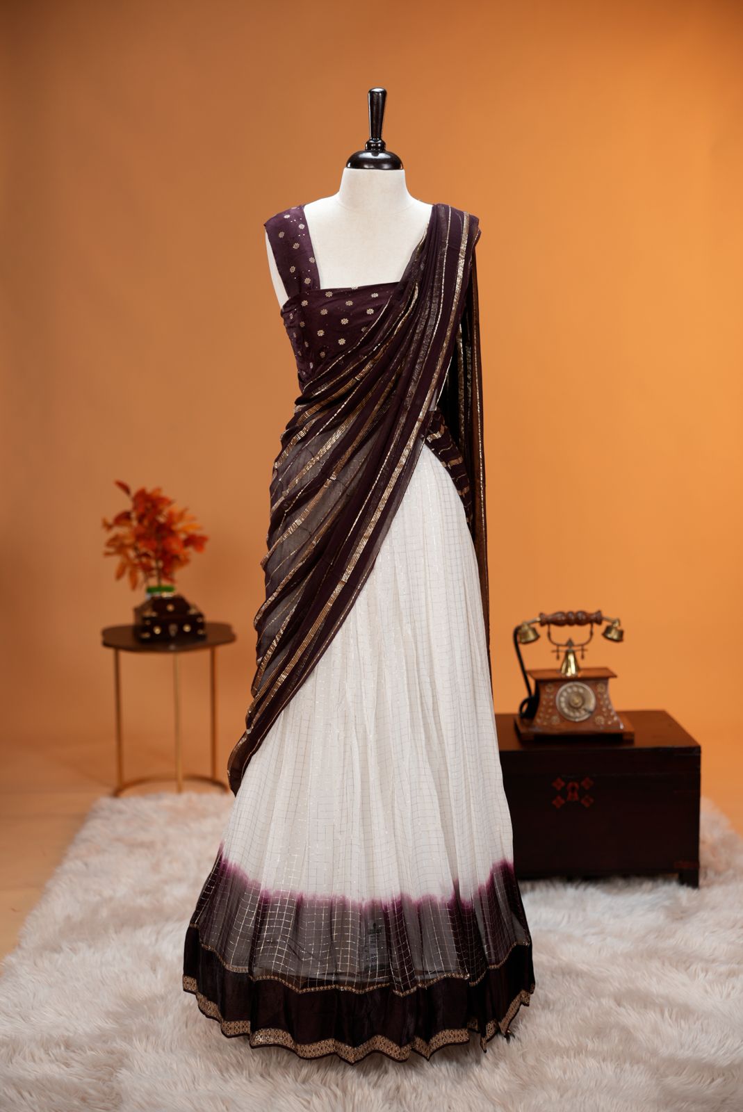Coffee Brown colour Georgette Dhavani material featuring white skirt with Check pattern & contrast border, Small floral work on blouse piece, same colour dupatta with strips..